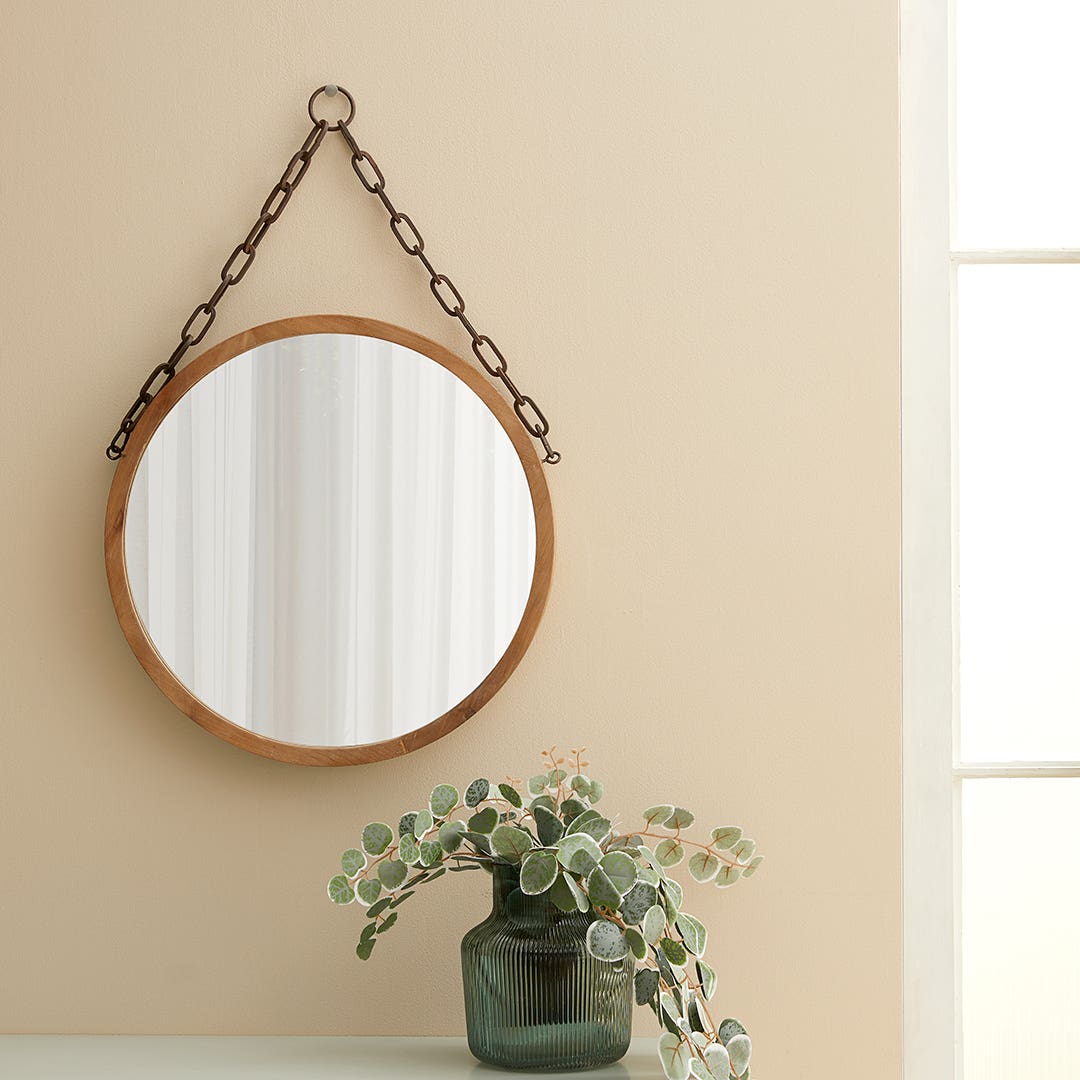 Hanging mirror top on wall