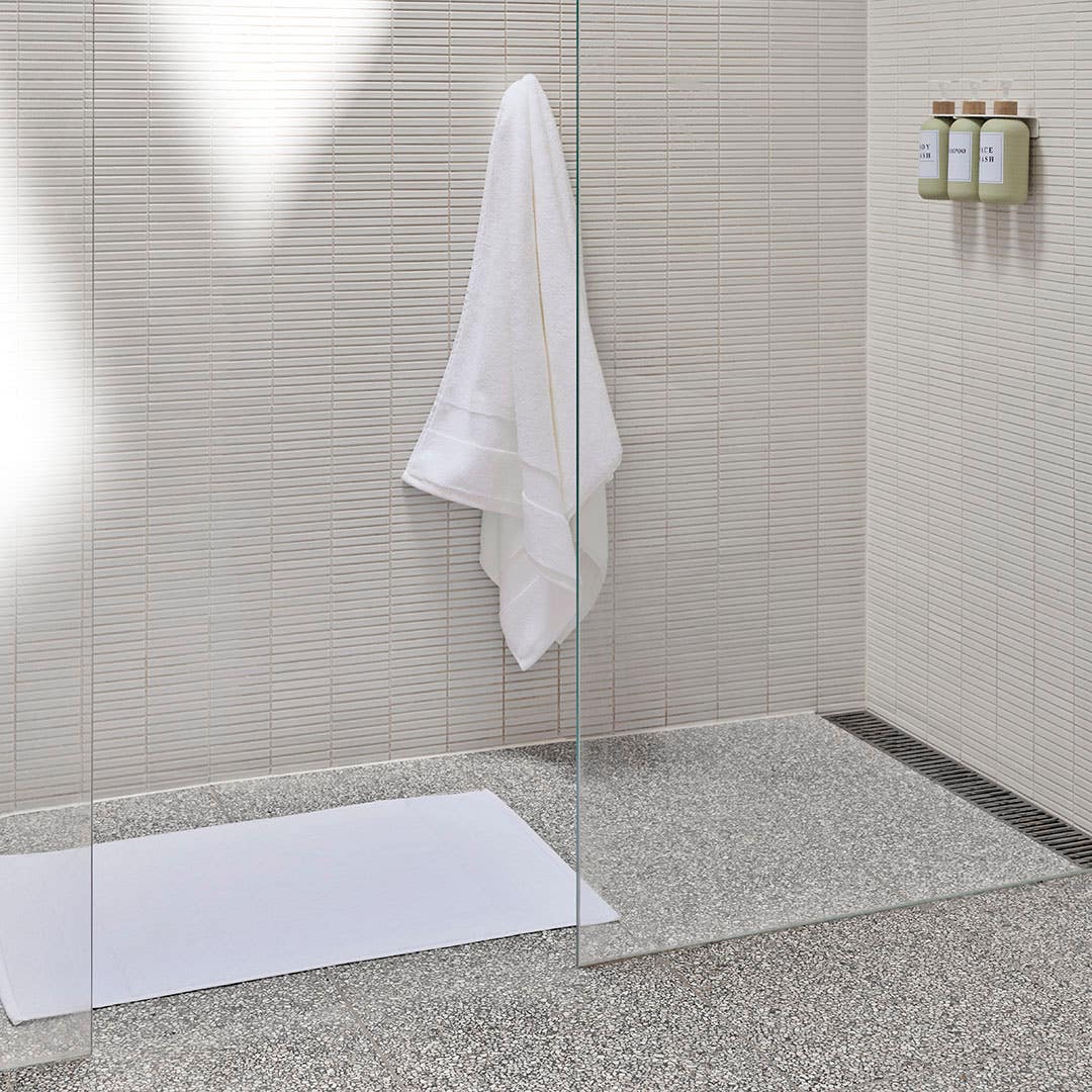https://s3-ap-southeast-2.amazonaws.com/fusionfactory.commerceconnect.bbnt.production/pim_media/000/200/494/M_F_Summer_S25-26_LS_Bathroom_Towel_Bathmat-Ultra_Soft_White_SI.jpg?1757027816