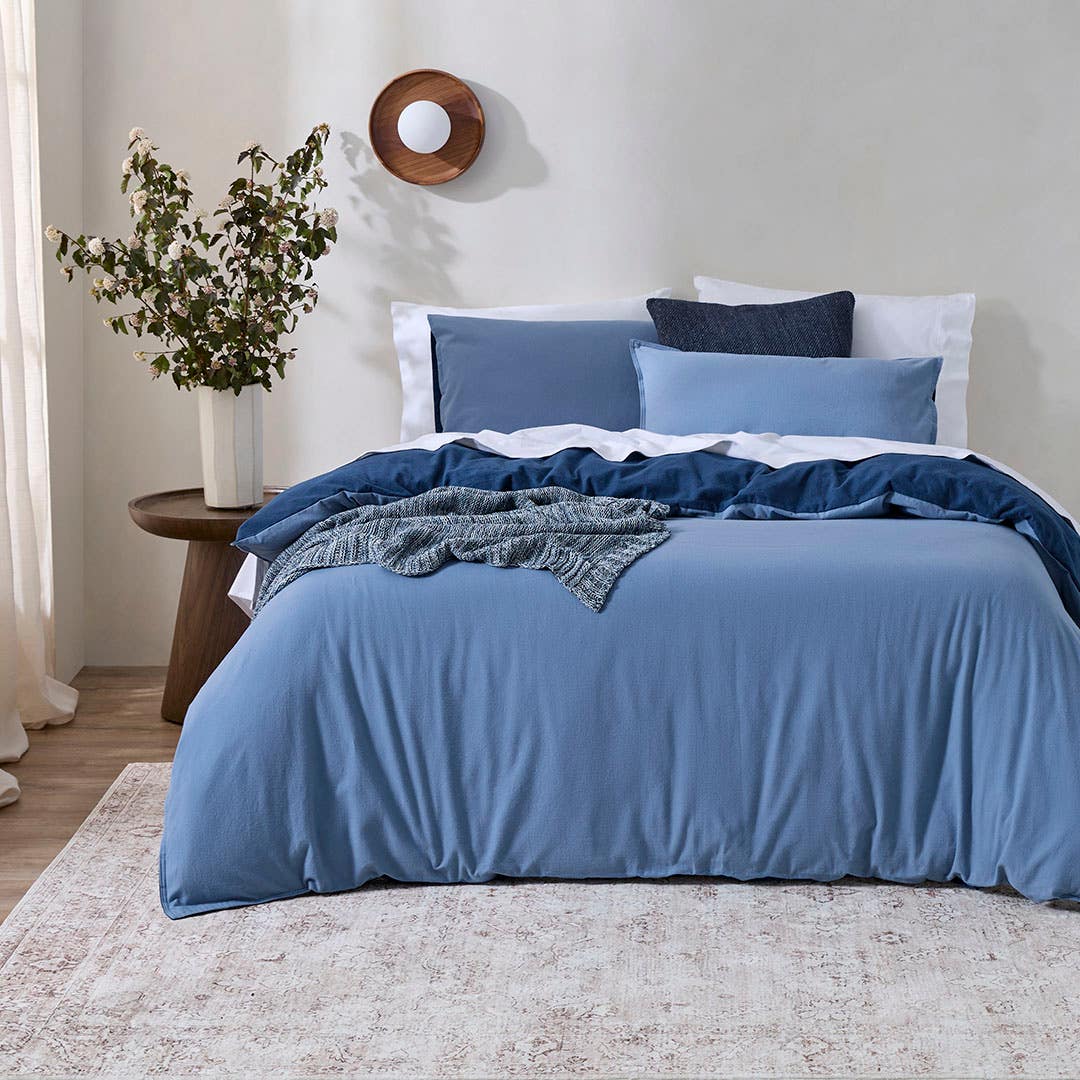 https://s3-ap-southeast-2.amazonaws.com/fusionfactory.commerceconnect.bbnt.production/pim_media/000/205/340/M_F_W26_Bedlinen_BOP_Fabian-Denim-Navy_V3_QQC_SI.jpg?1765323375