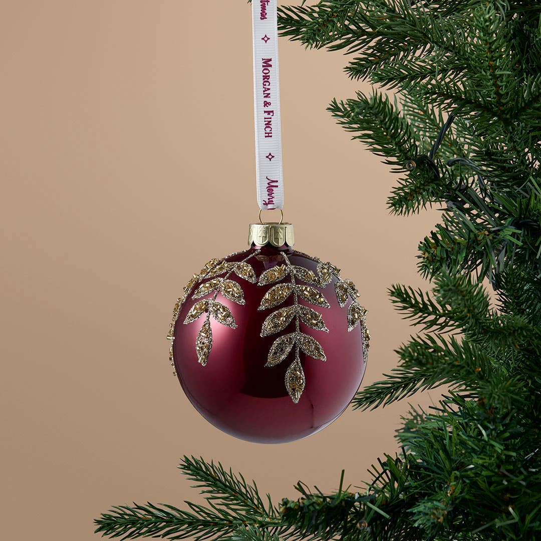 https://s3-ap-southeast-2.amazonaws.com/fusionfactory.commerceconnect.bbnt.production/pim_media/000/217/323/M_F_Xmas-26-27_S4_MR_DECS_Glass-Ball-w-Gold-Bead-Leaf-Burgundy_23214601_SI.jpg?1784079355